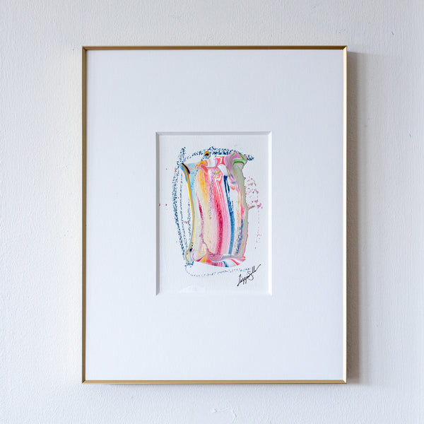 Framed abstract artwork with colorful design on a white wall