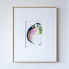 Framed abstract artwork with curved shape in gold frame on white wall