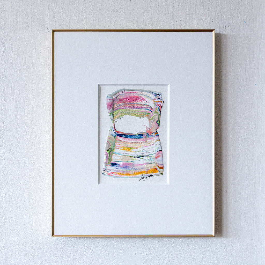 Framed abstract art painting on a white wall