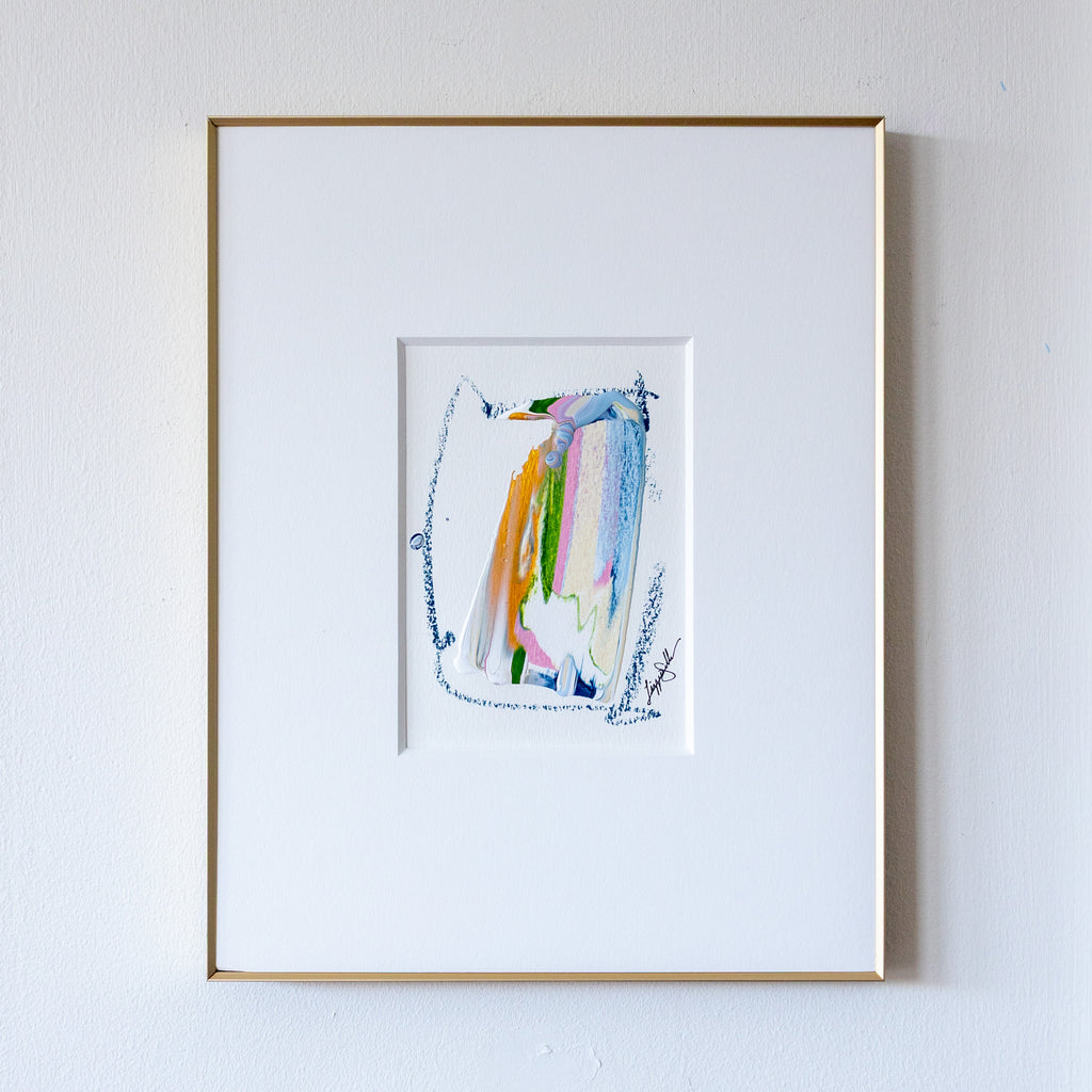 Acrylic abstract painting framed in slim gold frame on white wall