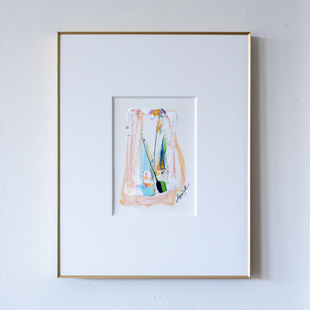 Soft pastel painting in slim gold frame on white wall