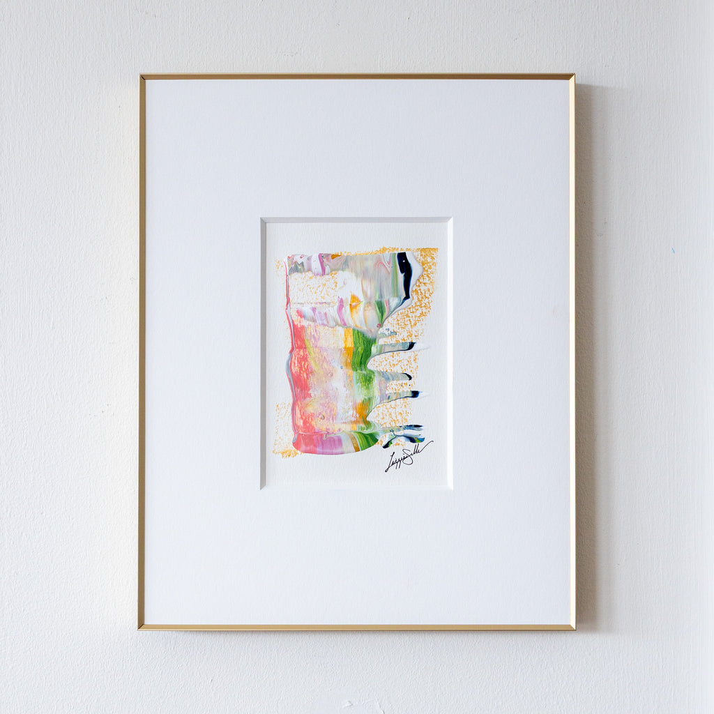Framed abstract acrylic and oil pastel painting on a white wall