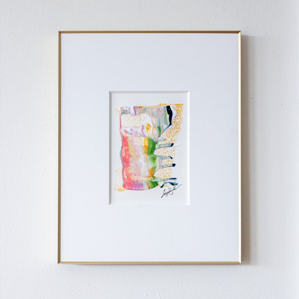 Framed abstract acrylic and oil pastel painting on a white wall