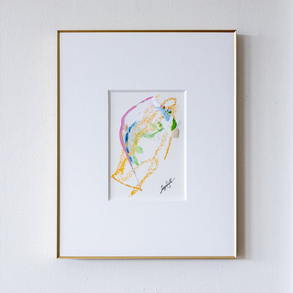 Framed abstract artwork with colorful design on a white wall