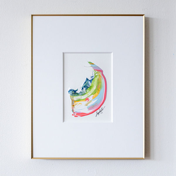 Framed abstract painting with colorful design on a white wall