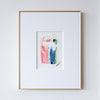 Framed abstract painting with colorful design on a white wall