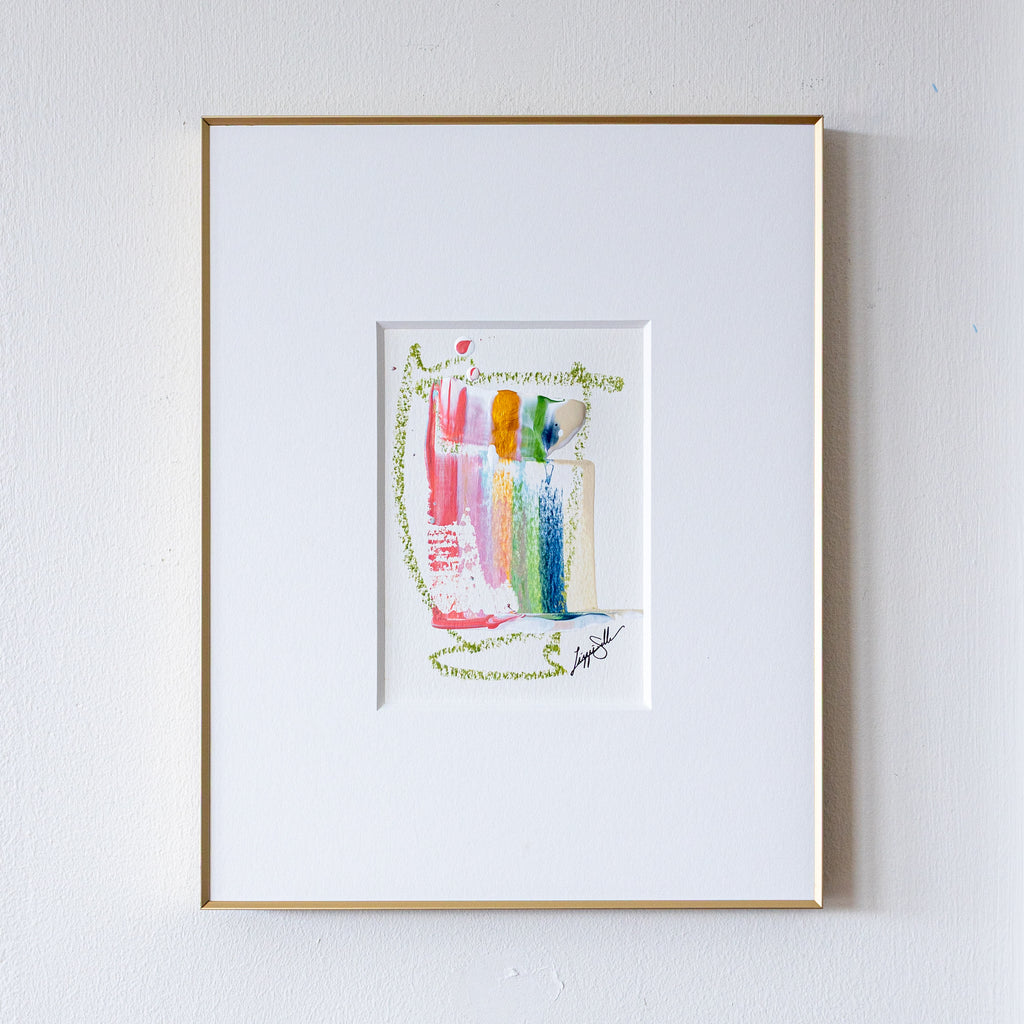 Framed artwork of colorful abstract painting on a white wall