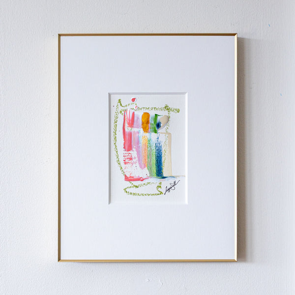 Framed artwork of colorful abstract painting on a white wall
