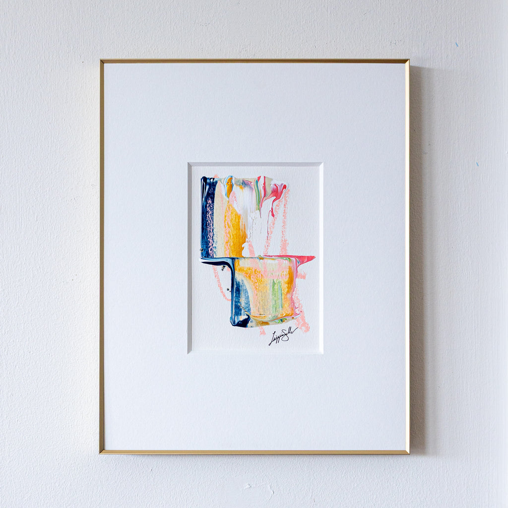 Framed abstract art painting on a white wall
