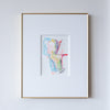 Framed abstract art painting with colorful shapes on a white wall