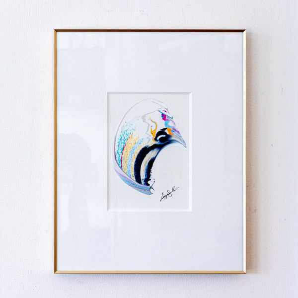 A framed original abstract painting set against a white mat and a thin gold frame, mounted on a white wall.