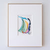 A framed abstract artwork featuring a colorful fluid swirl design in shades of blue, green, yellow, orange, pink, and black, presented in a white mat and a thin gold frame against a white wall.