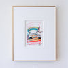 A framed abstract artwork featuring colorful horizontal brushstrokes, presented in a white mat and a thin gold frame against a white wall.