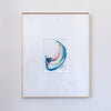 A framed abstract painting featuring a curved swish in shades of teal, coral and metallic gold, set within a white mat and a thin gold frame, mounted on a light gray wall.