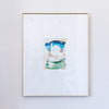 A framed painting featuring a colorful acrylic painting with blue, green, and white tones, set in a white mat and a thin gold frame against a white wall.