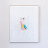 A framed abstract painting featuring a minimalist colorful figure in pink, gold, blue, and green on a white mat, enclosed in a light wood frame against a white wall.
