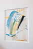 Abstract painting featuring blue, green, black, and gold in a white mat. Textural gold oil pastel markings