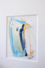 A framed abstract painting featuring a vertical swish in shades of blue, white, and yellow, displayed on a clean white wall.