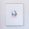 A framed abstract painting featuring blue, coral, blue, gold, and black in a white mat, enclosed in a thin gold frame against a light gray wall.