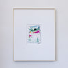 A framed abstract painting featuring colorful acrylic brushstrokes, presented in a white mat and a thin gold frame against a light gray wall.