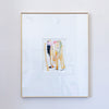 A framed abstract PAINTING featuring vertical brushstrokes in gold, pink, black, and green on a white mat, enclosed in a thin gold frame and hung on a light gray wall.