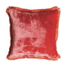 A square red velvet throw pillow with fringed edges, shown against a plain white background.