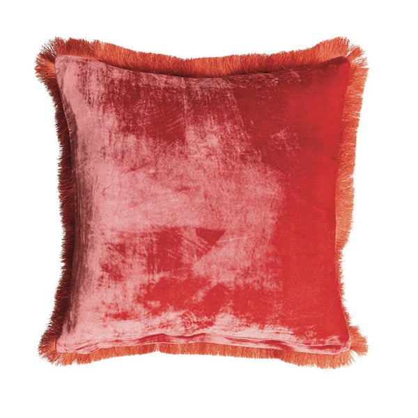 A square red velvet throw pillow with fringed edges, shown against a plain white background.