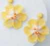 Beaded yellow flower earrings on white background