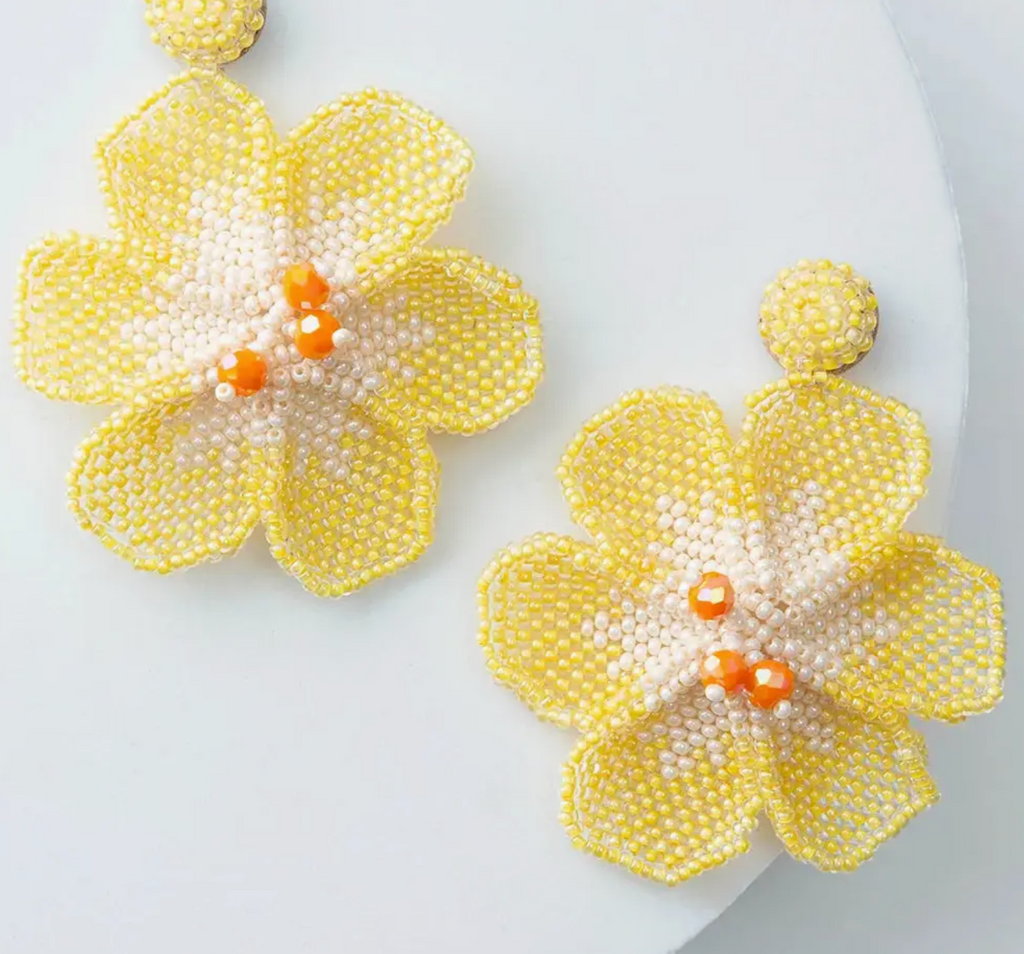 Beaded yellow flower earrings on white background