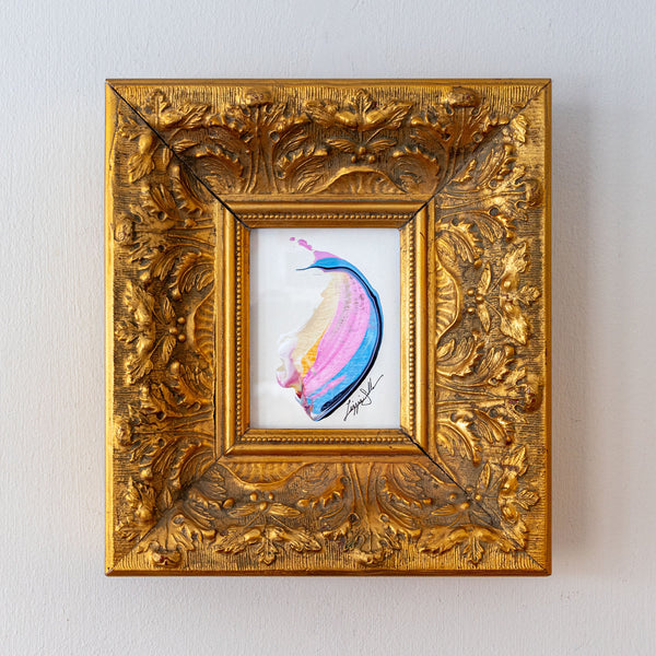 Decorative gold frame with a colorful abstract painting inside on a light gray background
