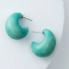 Turquoise hoop earrings on a white background