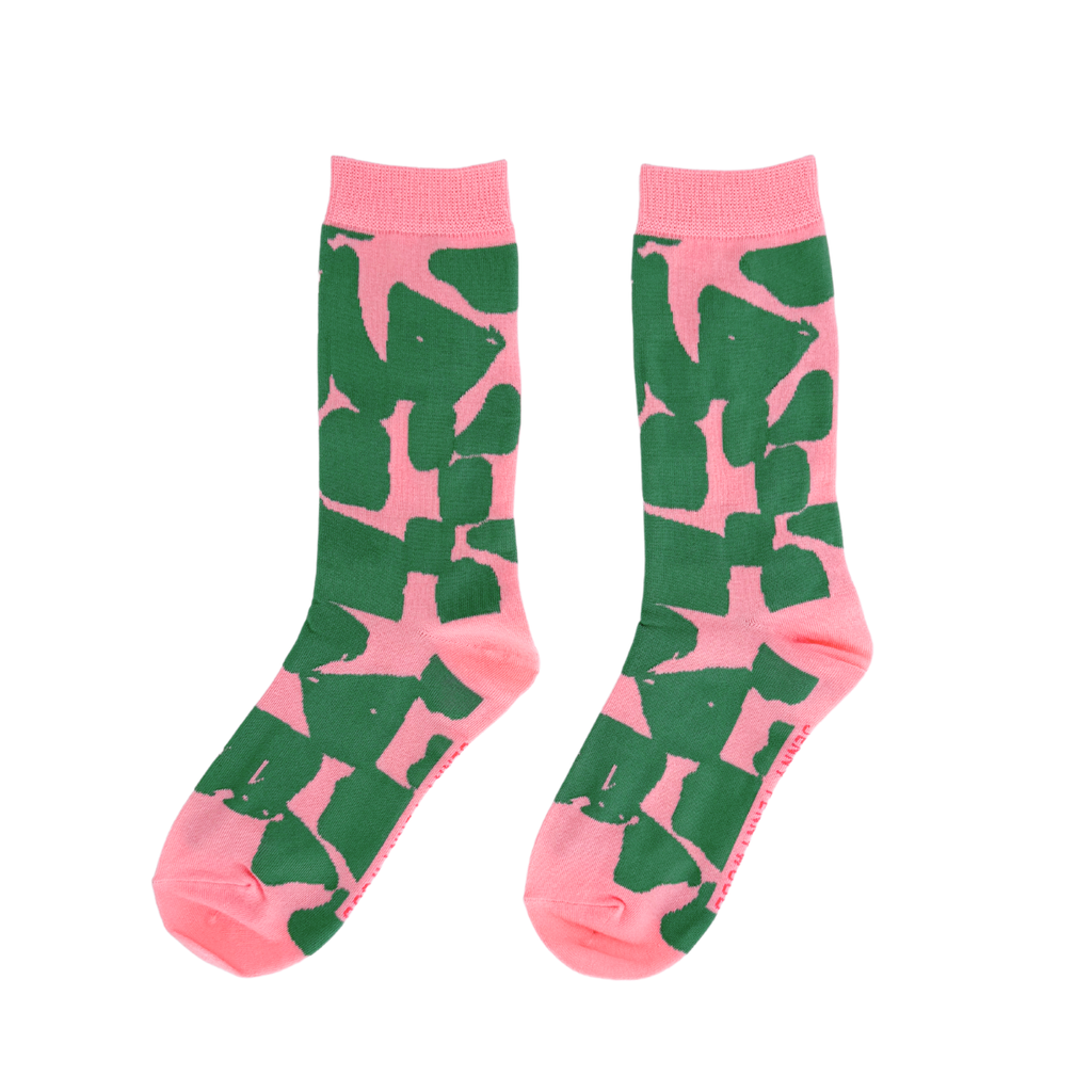 Pink socks with green abstract pattern on a white background