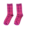 A pair of crew socks in a vibrant magenta pink color, featuring a lighter hot pink grid plaid pattern, displayed against a solid white background.