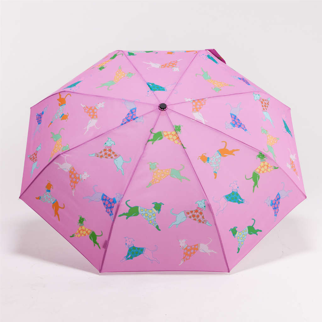 Pink umbrella with colorful dog pattern on a white background