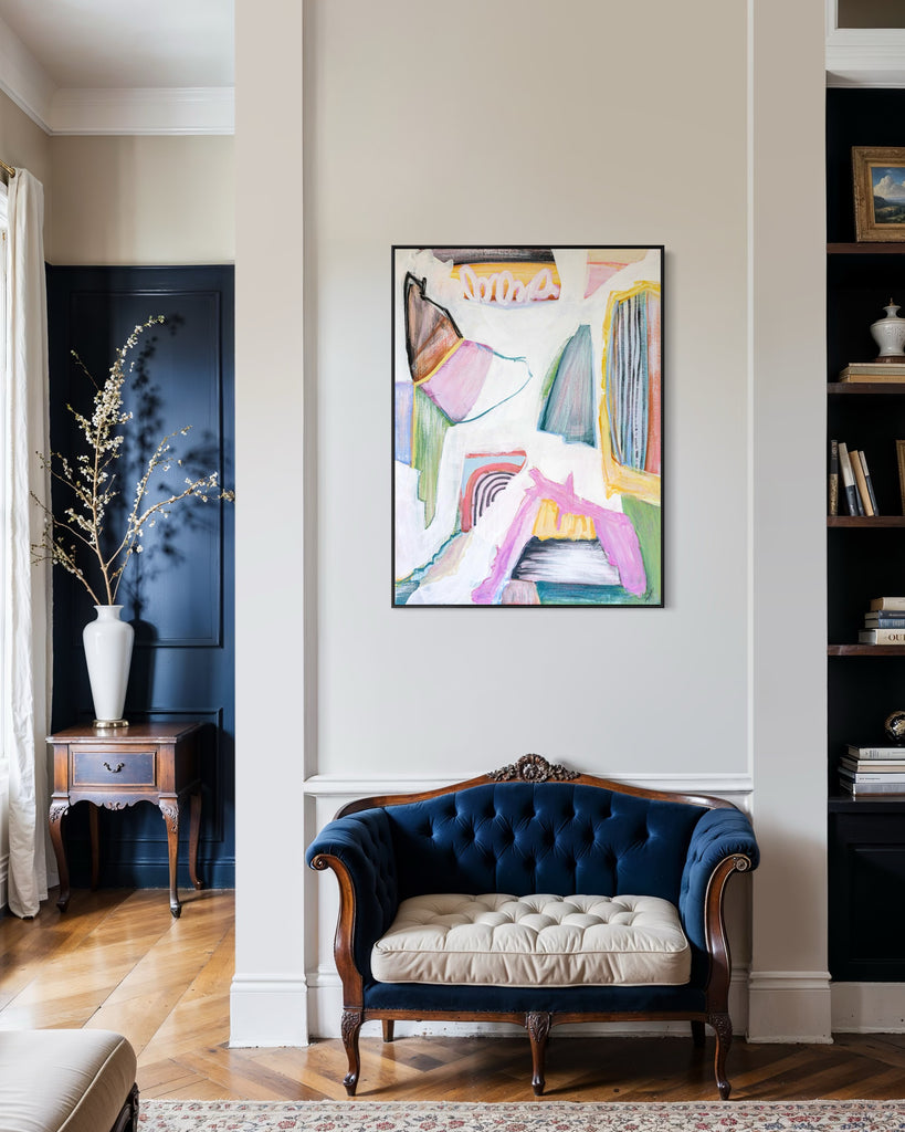 Living room with a colorful abstract painting on the wall above a blue tufted sofa.