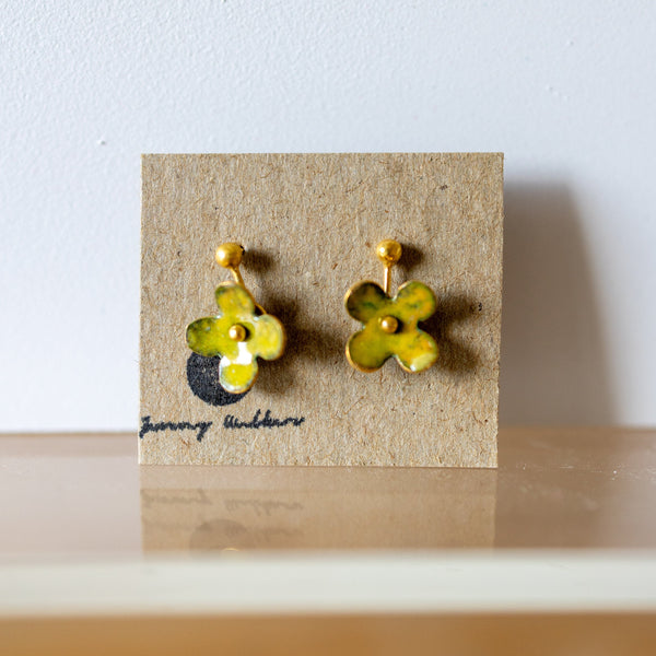Pair of yellow flower-shaped earrings on a brown card with 'Jewelry Addict' branding.