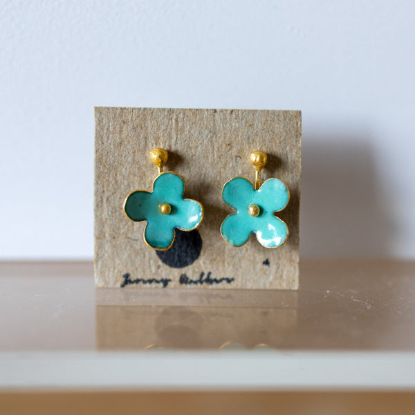 Turquoise flower earrings on a cardboard backing with 'Jewelry Addicts' branding.