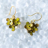 Floral earrings with gold accents on a textured white background