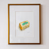 Framed artwork of a butter container on a white wall