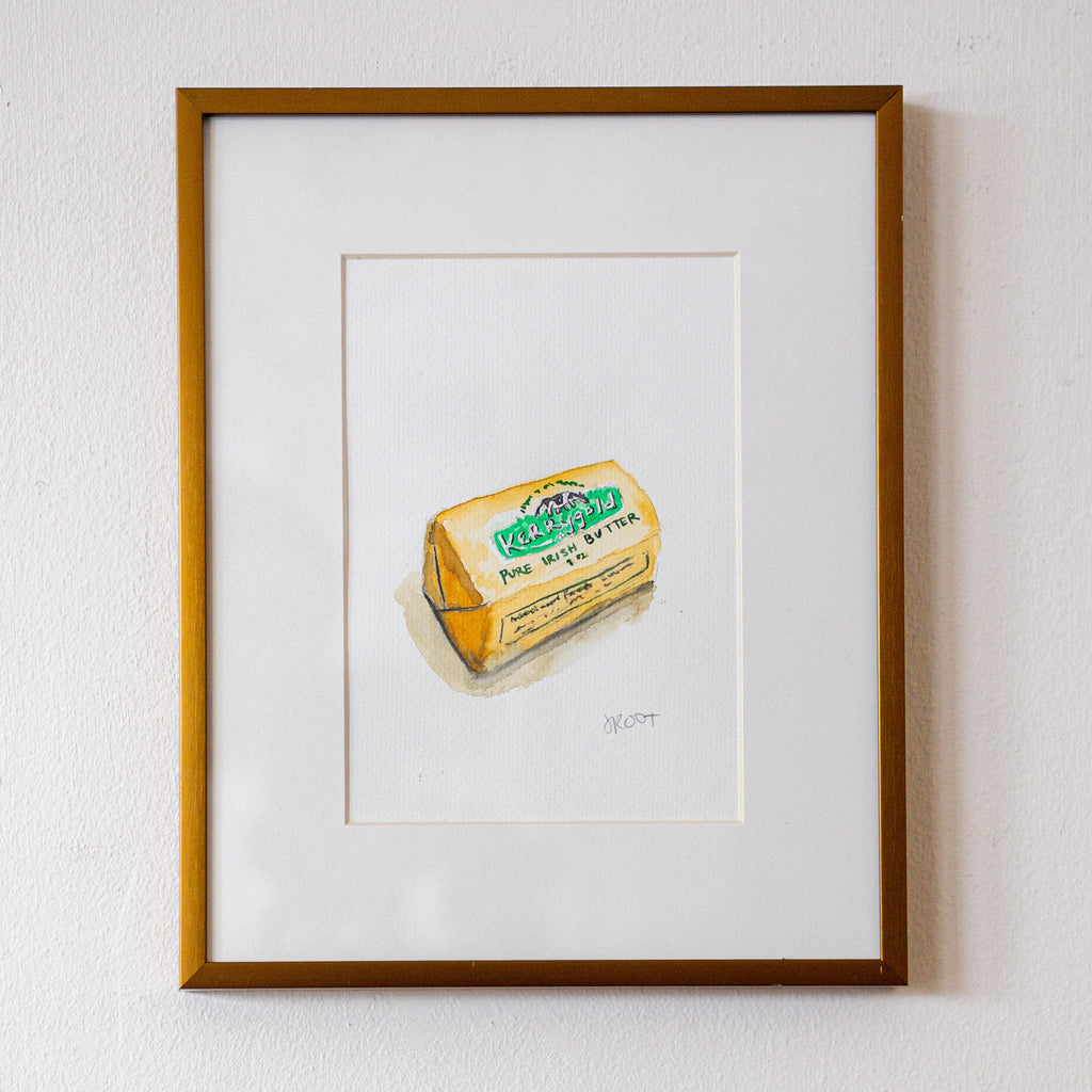 Framed artwork of a butter container on a white wall