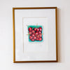 Framed artwork of cherries on a white wall