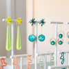 Collection of colorful earrings on display stands in a room.