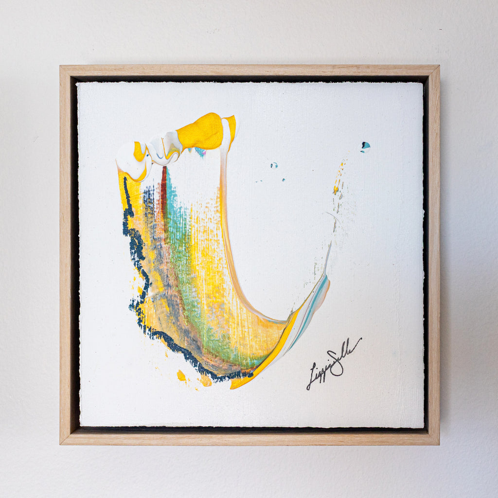 Metallic gold and navy abstract framed art on white background
