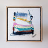 Framed abstract art with colorful brush strokes on a white background