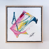 Framed abstract artwork with colorful splashes on a white background