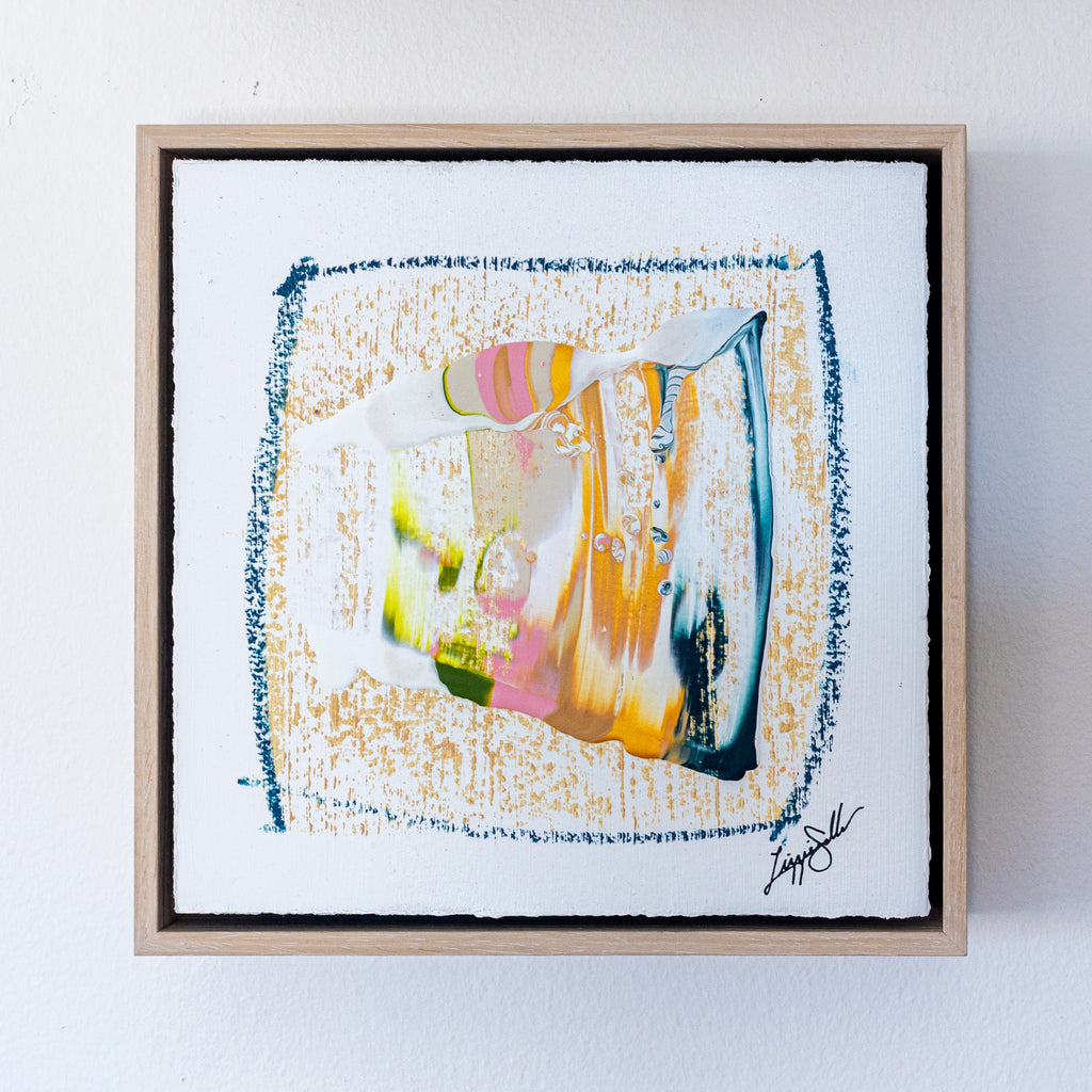Framed abstract artwork with colorful design on a white background