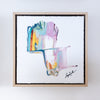 Framed abstract artwork with colorful brush strokes on a white background