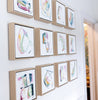 Grid of framed abstract artworks on a wall