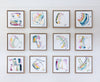 Grid of framed abstract artworks on a white wall