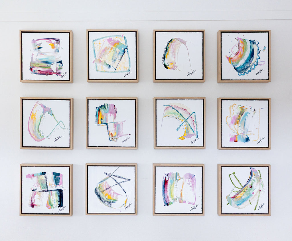 Grid of framed abstract artworks on a white wall